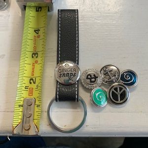 One 4.5” black leather strap key rings for changeable snap and 5 snaps.. NWOT.